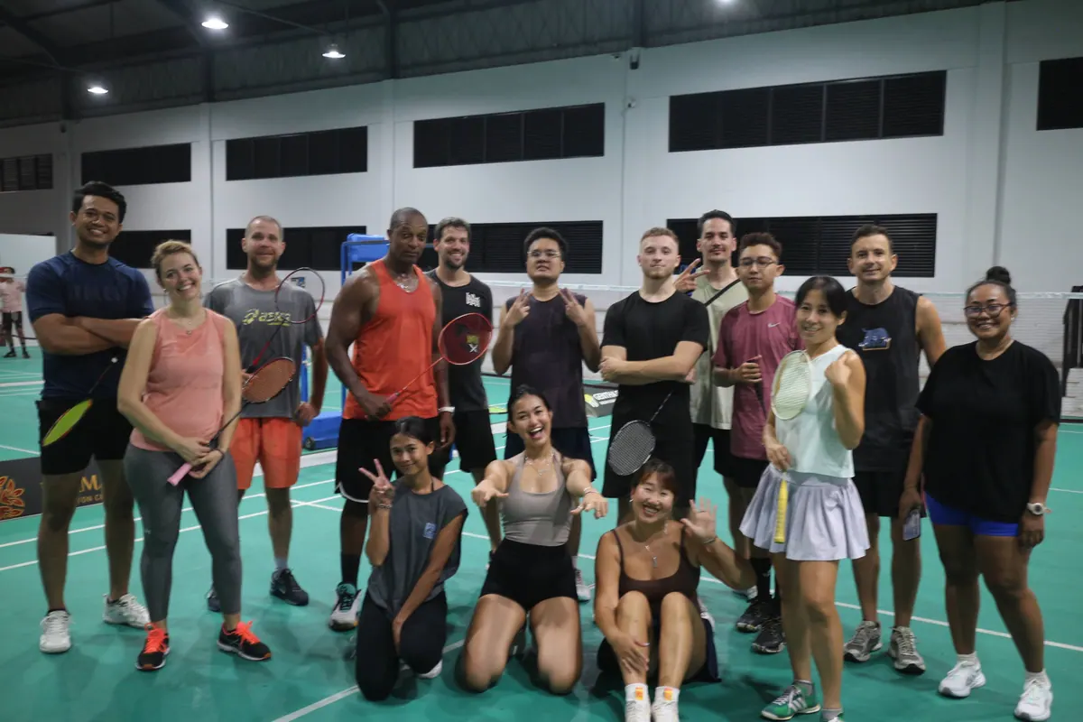 Sailia Badminton group photo on court, rackets up, September 2026